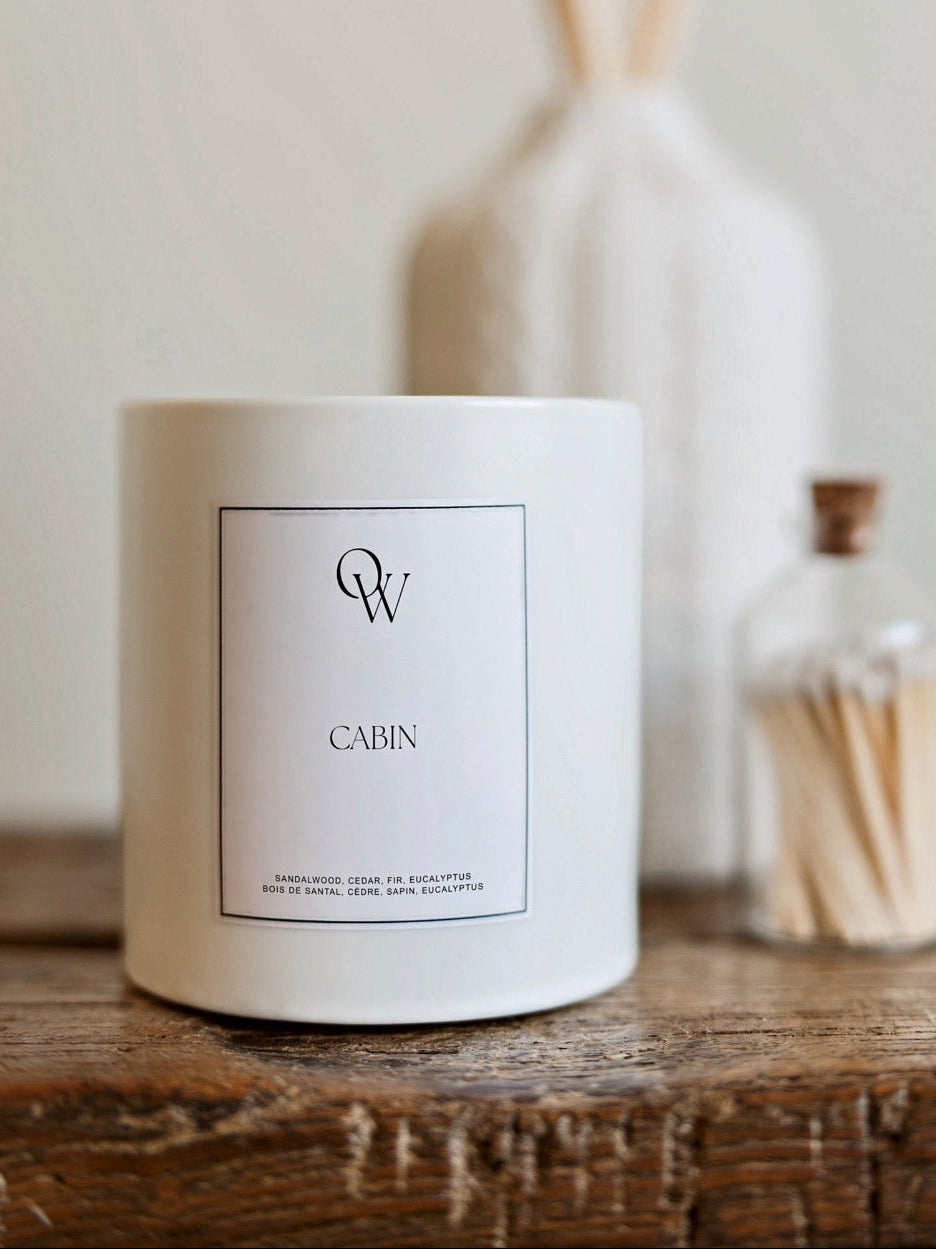 One Wednesday Cabin soy candle in a white vessel.