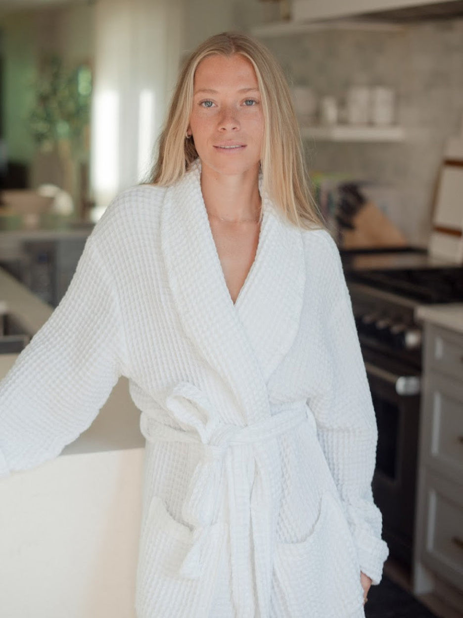 Model wearing the light grey Waffle Knit Robe with the belt tied in a bow
