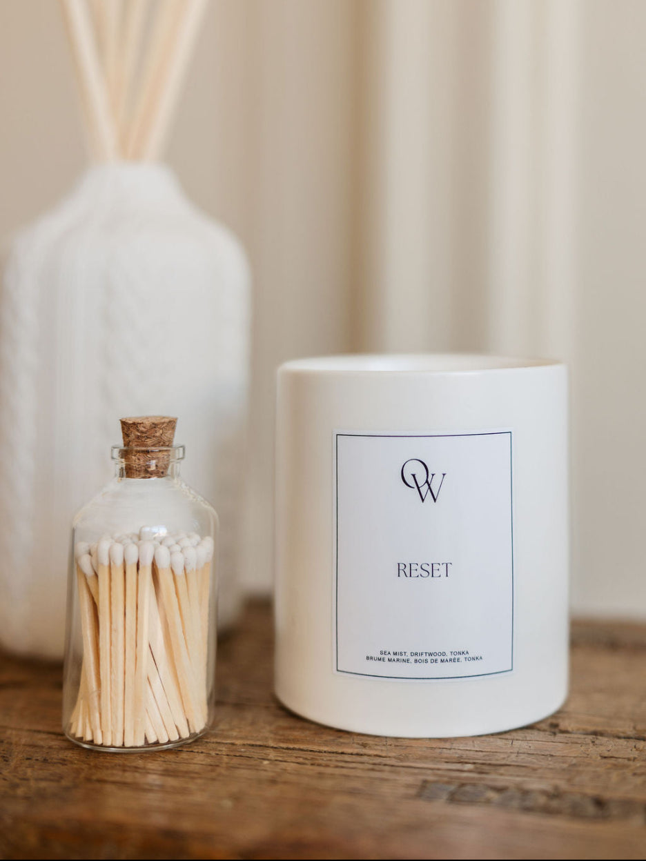 One Wednesday Reset soy candle in a white vessel.