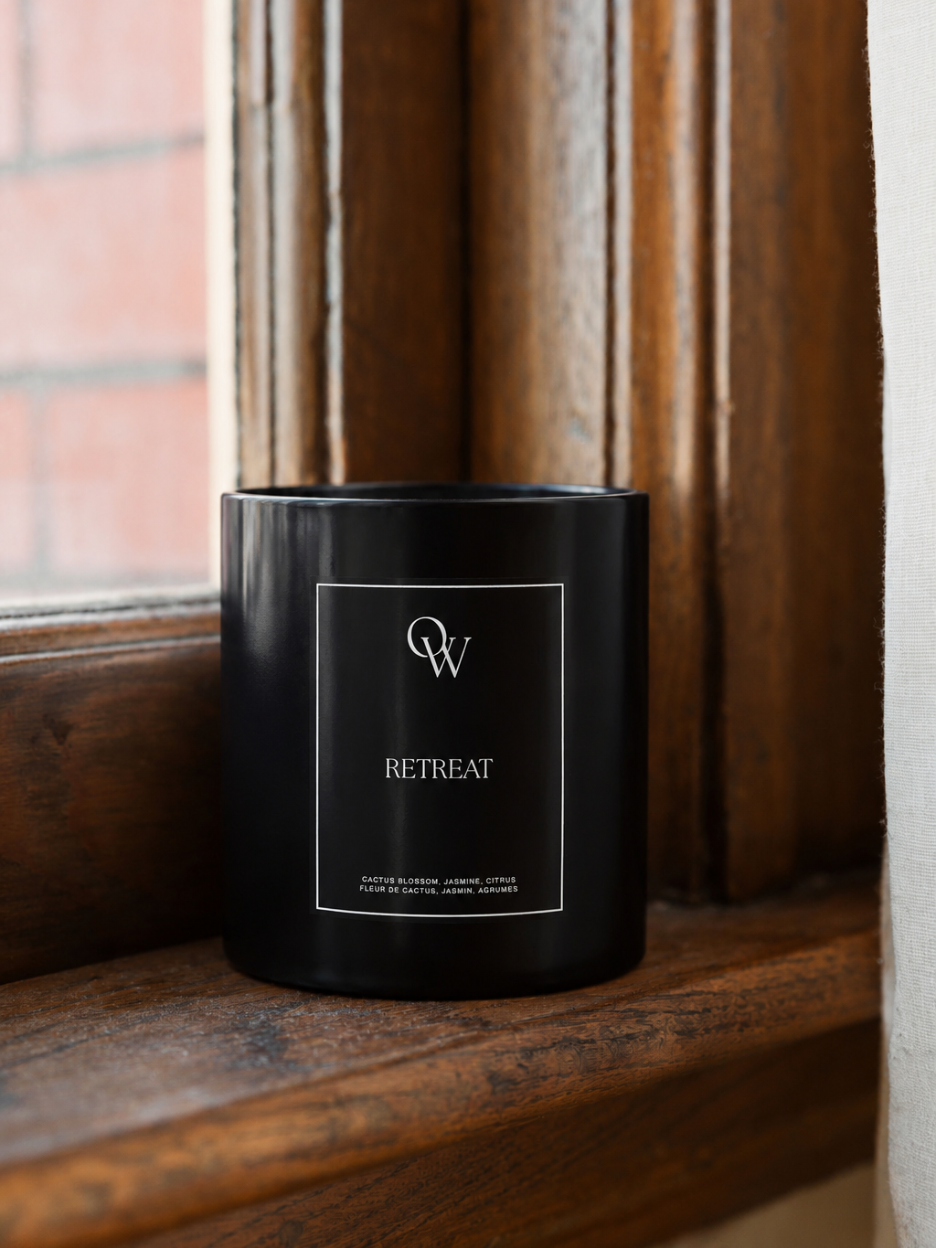 One Wednesday Retreat soy candle in a black vessel.