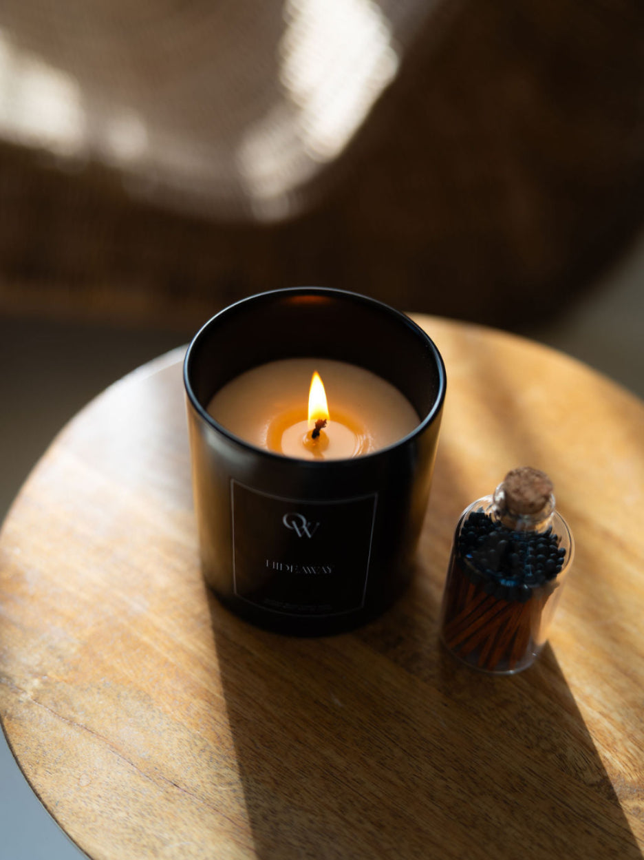 One Wednesday Hideaway candle in a black vessel.